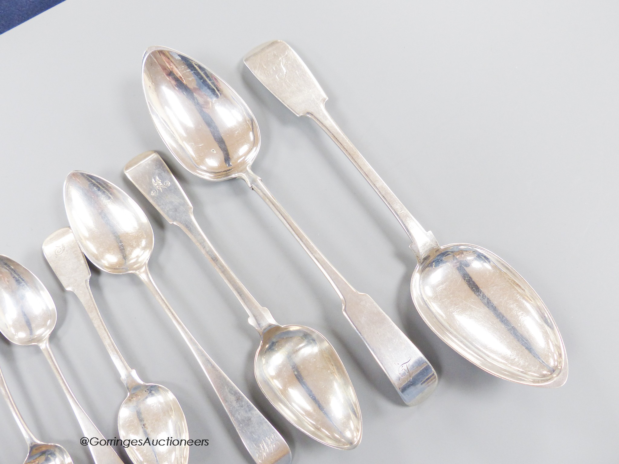 A collection of thirteen mainly 19th century Scottish provincial Banff silver spoons, including two fiddle pattern table spoons, John Keith & William Simpson, 22.5cm, two dessert spoons, John Keith and George Elder and n